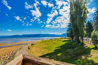 a view of a beach with people walking on the grass at Overlook Nook in Stateline