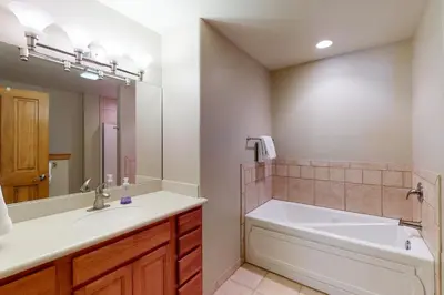 a bathroom with a tub and a sink and a bath tub at Snow Porch in Truckee