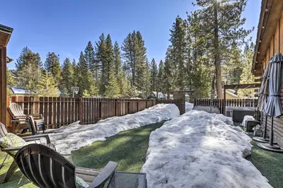 a yard covered in snow next to a fence at Dog-Friendly Kings Beach Log Cabin with Hot Tub! in Kings Beach