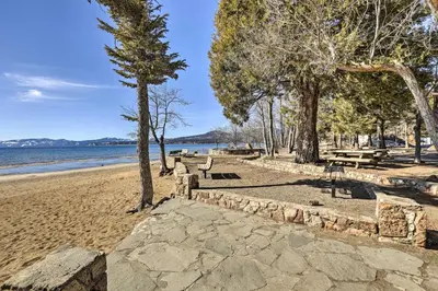 a sandy beach with benches and trees and the water at Dog-Friendly Kings Beach Log Cabin with Hot Tub! in Kings Beach