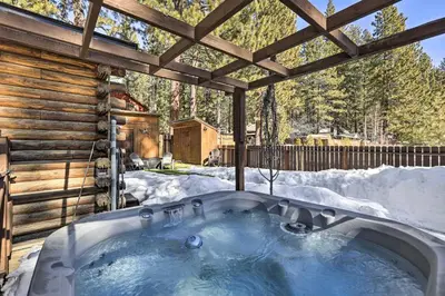 a hot tub in the snow in a cabin at Dog-Friendly Kings Beach Log Cabin with Hot Tub! in Kings Beach