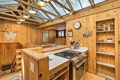 a kitchen with wooden walls and a ceiling with a clock at Less Than 1 Mi to Heavenly Lifts Tahoe Area Townhome! in Stateline