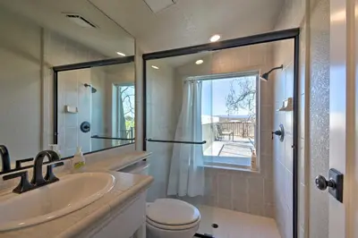 a bathroom with a shower and a sink and a toilet at Picturesque Farmhouse on Working Almond Ranch in Oakdale