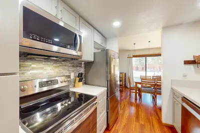 a kitchen with a stove and a microwave at Snowcreek 27 in Mammoth Lakes