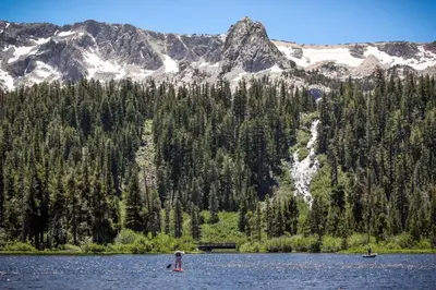 two people in a lake with mountains in the background at Snowcreek 27 in Mammoth Lakes