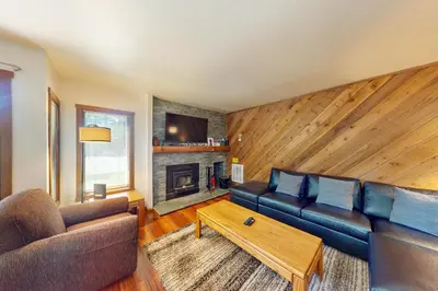 a living room with a couch and a table at Snowcreek 27 in Mammoth Lakes