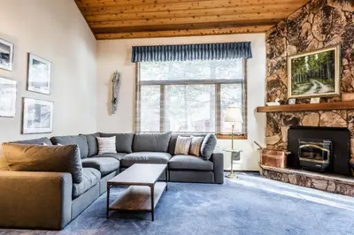 a living room with a couch and a fireplace at Spacious Winterset 26 2 Bedrm Plus Loft 3 Full Bathrm Townhome Sleeps 8 Steps to Free Town Shuttle in Mammoth Lakes