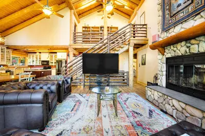 a living room with a tv and a fireplace at The Cub Inn in Groveland