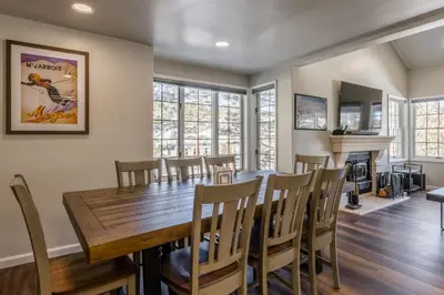 a dining room with a wooden table and chairs at Ski in Ski Out 3 Bedrm 3 Bathrm fully remodeled Sierra Megeve Condo Steps to Canyon Lodge Sleeps 8 in Mammoth Lakes