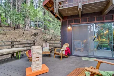 a screened in porch of a house with a table and chairs at Walk Downtown Arnold Cabin with Large Deck! in Arnold