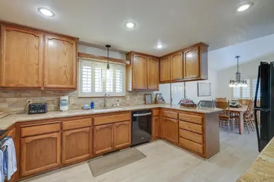a kitchen with wooden cabinets and a dining room at Hikers Escape Home Near Beach, Golf and Yosemite in Groveland