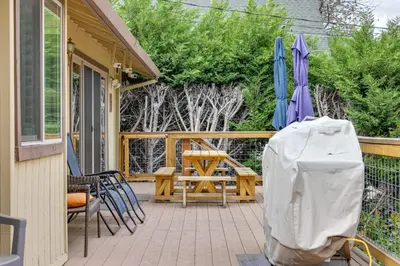 a patio with a table and chairs and an umbrella at Hikers Escape Home Near Beach, Golf and Yosemite in Groveland