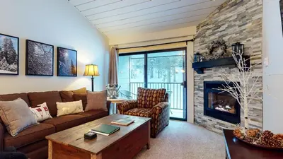 a living room with a couch and a fireplace at St, Anton #54 condo in Mammoth Lakes