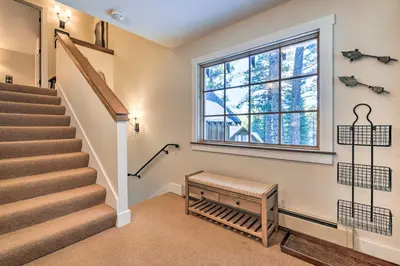 a staircase in a house with a window at Furnished Deck Cabin on Northstar Shuttle Route! in Truckee