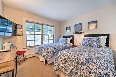 a bedroom with two beds and a window at Furnished Deck Cabin on Northstar Shuttle Route! in Truckee