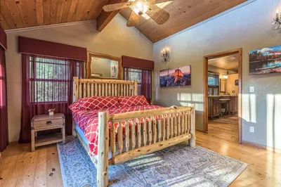 a bedroom with a bed and a ceiling fan at Red Oasis in Oakhurst