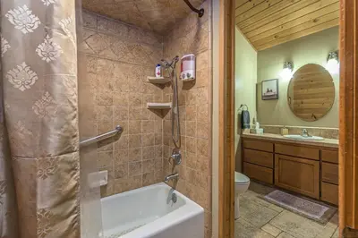 a bathroom with a tub and a toilet and a sink at Red Oasis in Oakhurst