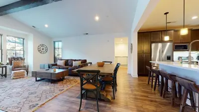 a kitchen and living room with a table and chairs at Snowcreek VII #1403 condo in Mammoth Lakes