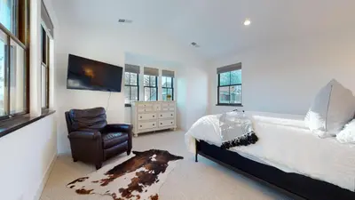 a bedroom with a bed and a chair and a tv at Snowcreek VII #1403 condo in Mammoth Lakes