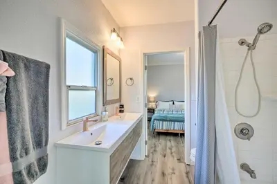 a white bathroom with a sink and a shower at Pet-Friendly Sacramento Home about 5 to Downtown! in Sacramento