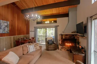 a living room with a couch and a fireplace at Woodsy retreat near Northstar & lake in Kings Beach