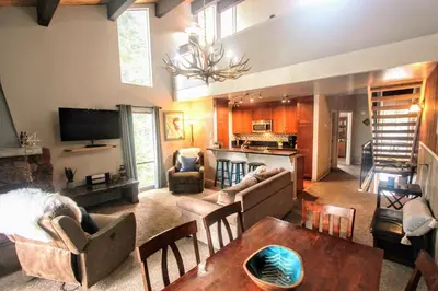 a living room with a couch and a table at Woodsy retreat near Northstar & lake in Kings Beach