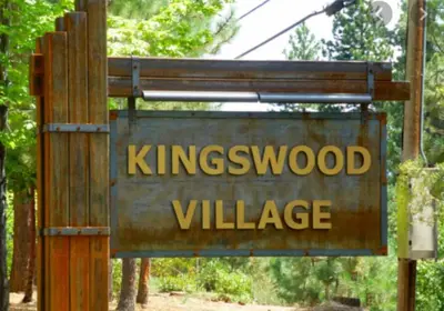 a sign for kingswood village on a wooden pole at Woodsy retreat near Northstar & lake in Kings Beach