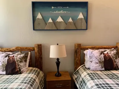 a bedroom with two beds and a picture on the wall at Woodsy retreat near Northstar & lake in Kings Beach