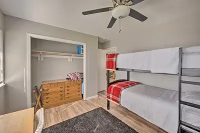 a bedroom with two bunk beds and a ceiling fan at Authentic Escape at the Exact Center of CA! in North Fork