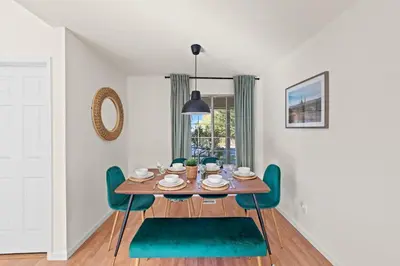 a dining room with a wooden table and green chairs at Delightful 4BR Home Nr Downtown Reno w Fireplace in Reno
