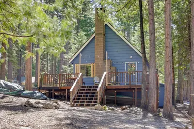 a tiny house in the woods with a deck at 3 Mi to Big Trees State Park Cabin with Scenic Deck in Arnold