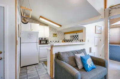 a living room with a couch and a kitchen at Sunny Studio Ski Loft - Creekside #103 in Bear Valley