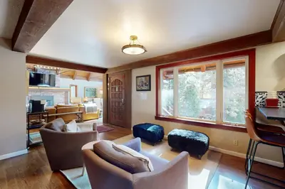 a living room with couches and a window at The Chalet in Zephyr Cove