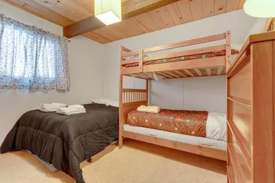 a bedroom with two bunk beds in a room at Popular A-frame Cabin With Deck & Views - Vh 216 in Bear Valley