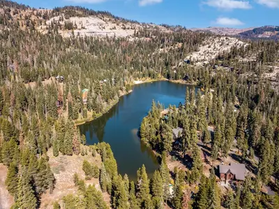 an aerial view of a lake in a forest at Spacious Cabin Sleeps up to 12 - Sky High #86 in Bear Valley