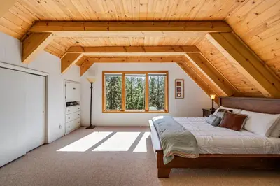 a bedroom with a bed and a wooden ceiling at Mountain Getaway with Granny Unit, Dogs Ok #47 in Bear Valley