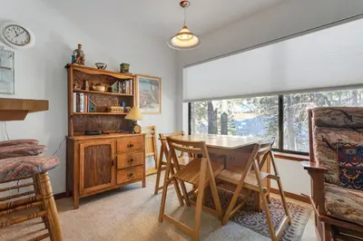 a dining room with a table and chairs and a window at Year Round Condo- Sleeps 5! - Tamarack #17 in Bear Valley