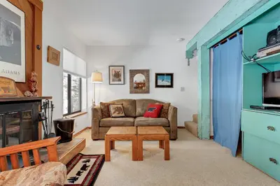a living room with a couch and a table at Year Round Condo- Sleeps 5! - Tamarack #17 in Bear Valley