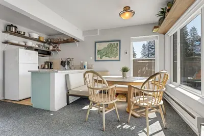 a kitchen and dining room with a table and chairs at Great Location Corner Condo - Tamarack #10 Pets Ok in Bear Valley