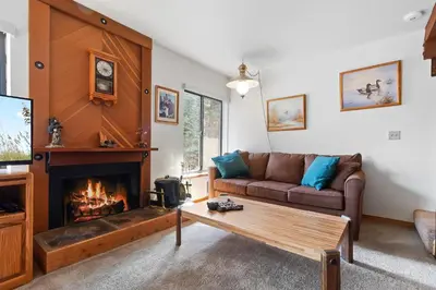 a living room with a couch and a fireplace at Comfortable Condo Great Location- Tamarack #12 in Bear Valley
