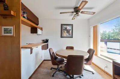 a kitchen and dining room with a table and chairs at Comfortable Condo Great Location- Tamarack #12 in Bear Valley