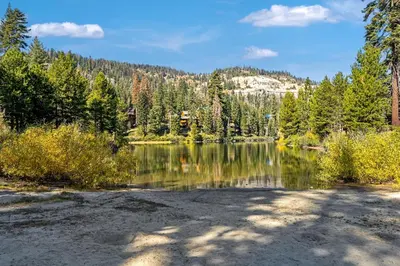 a lake with trees and a mountain in the background at Relaxing, Well Furnished Condo! - Creekside #29 in Bear Valley