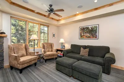 a living room with a couch and chairs at Luxurious Modern Condo! - SM #207 in Bear Valley