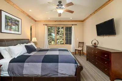a bedroom with a bed and a flat screen tv at Luxurious Modern Condo! - SM #207 in Bear Valley
