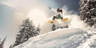a person doing a trick on a snowboard in the air at Sunny, Spacious & Pet Friendly - Creekside #39 in Bear Valley