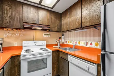 a kitchen with a white stove and a sink at Sunny, Spacious & Pet Friendly - Creekside #39 in Bear Valley