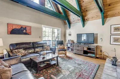 a living room with leather furniture and a flat screen tv at Multi-Family Cabin in Great Location #183 in Bear Valley