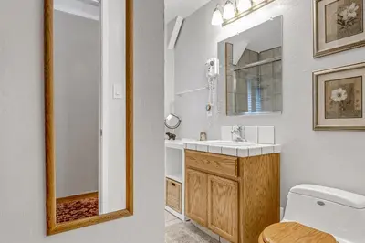 a bathroom with a sink and a toilet and a mirror at Multi-Family Cabin in Great Location #183 in Bear Valley