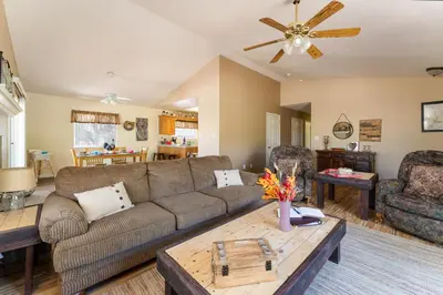 a living room with a couch and a table at Lazy Squirrel - Cozy Family House with Full Game Room in Kernville