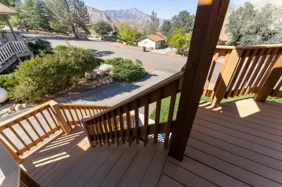 a wooden deck with a view of a street at Epic View A Luxury House on a Hill River 10 min in Kernville